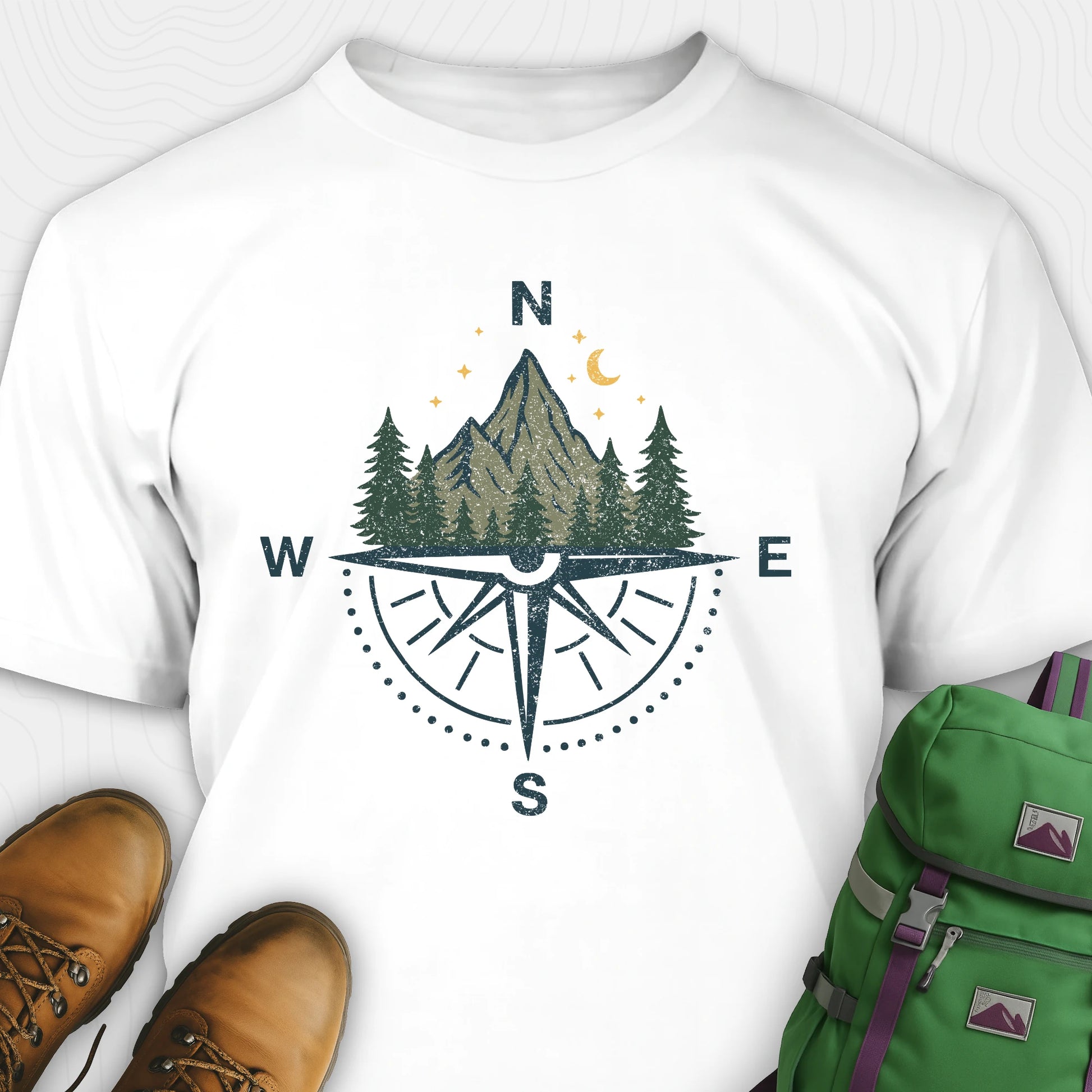 White compass shirt with mountains and pine trees design