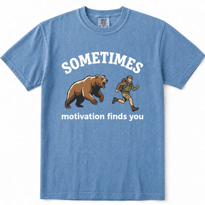 Blue Jean crewneck t-shirt featuring a graphic print of a brown bear and a hiking trail runner with the text 'SOMETIMES motivation finds you' in white.