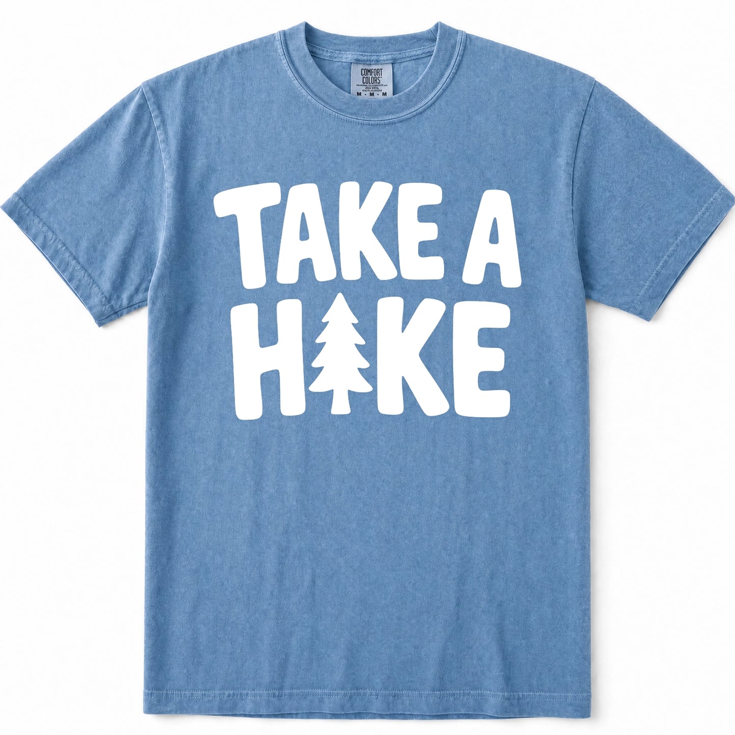 Blue Jean short-sleeve crewneck t-shirt with a bold white graphic print on the front reading 'TAKE A HIKE' with a pine tree icon replacing the letter 'I'.