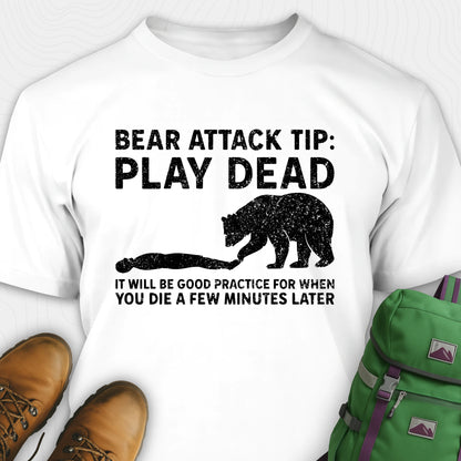 White bear tee shirt with bear graphic and text, green backpack, and brown boots on a white background