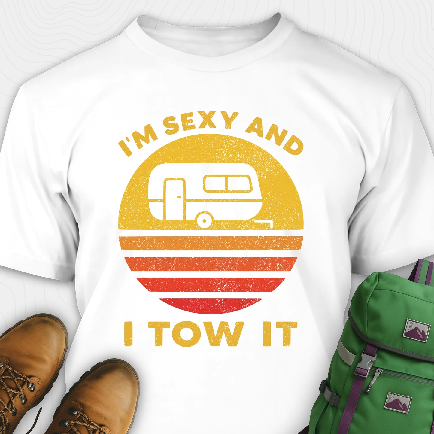 White trailer shirt with retro camper and sunset graphic, and "I'm sexy and I tow it" text