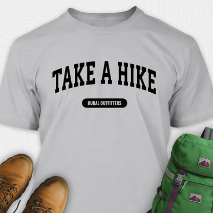 Gray t-shirt with 'Take a Hike' text, brown boots, and green backpack on a white background