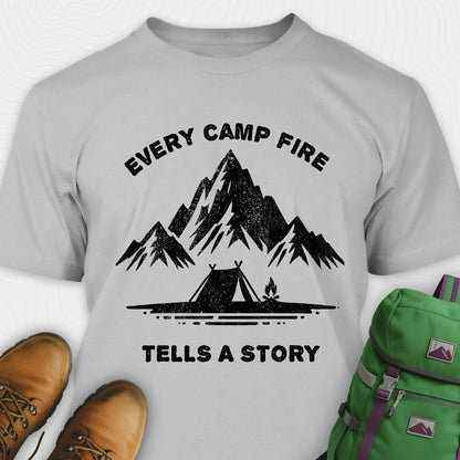 Gray campfire story shirt with mountains and tent graphic and "every camp fire tells a story" text