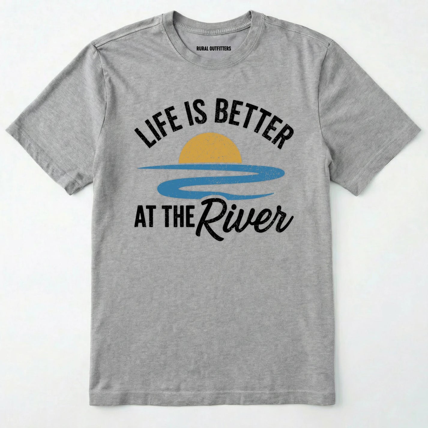 Sport Grey river shirt with 'life is better at the river' design, paired with brown boots and a green backpack on a light grey background.