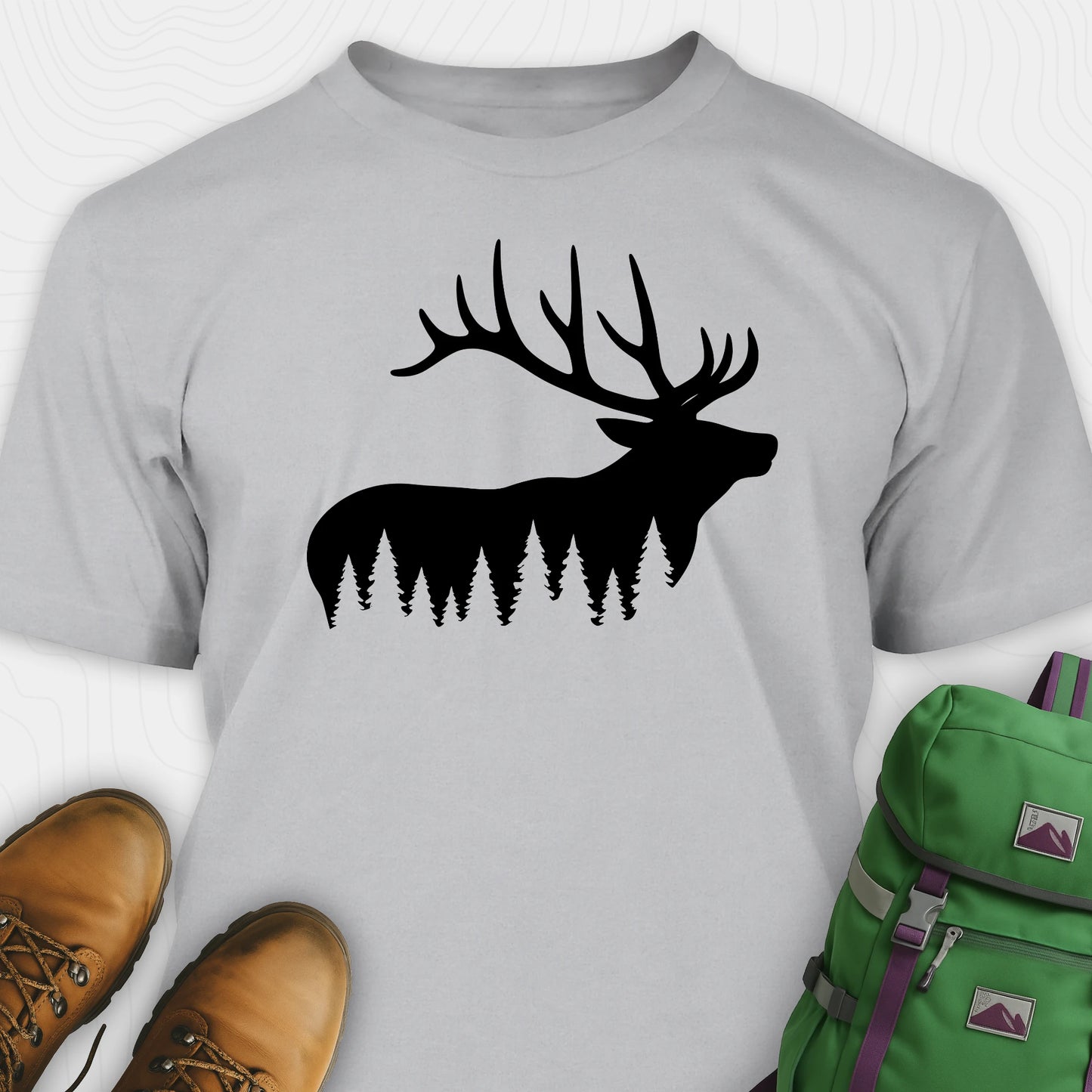 Gray elk shirt with black elk silhouette design, paired with brown boots and a green backpack on a white background.