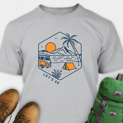 Gray let’s go t-shirt with retro camper van and sunset graphic, and green backpack on a white background