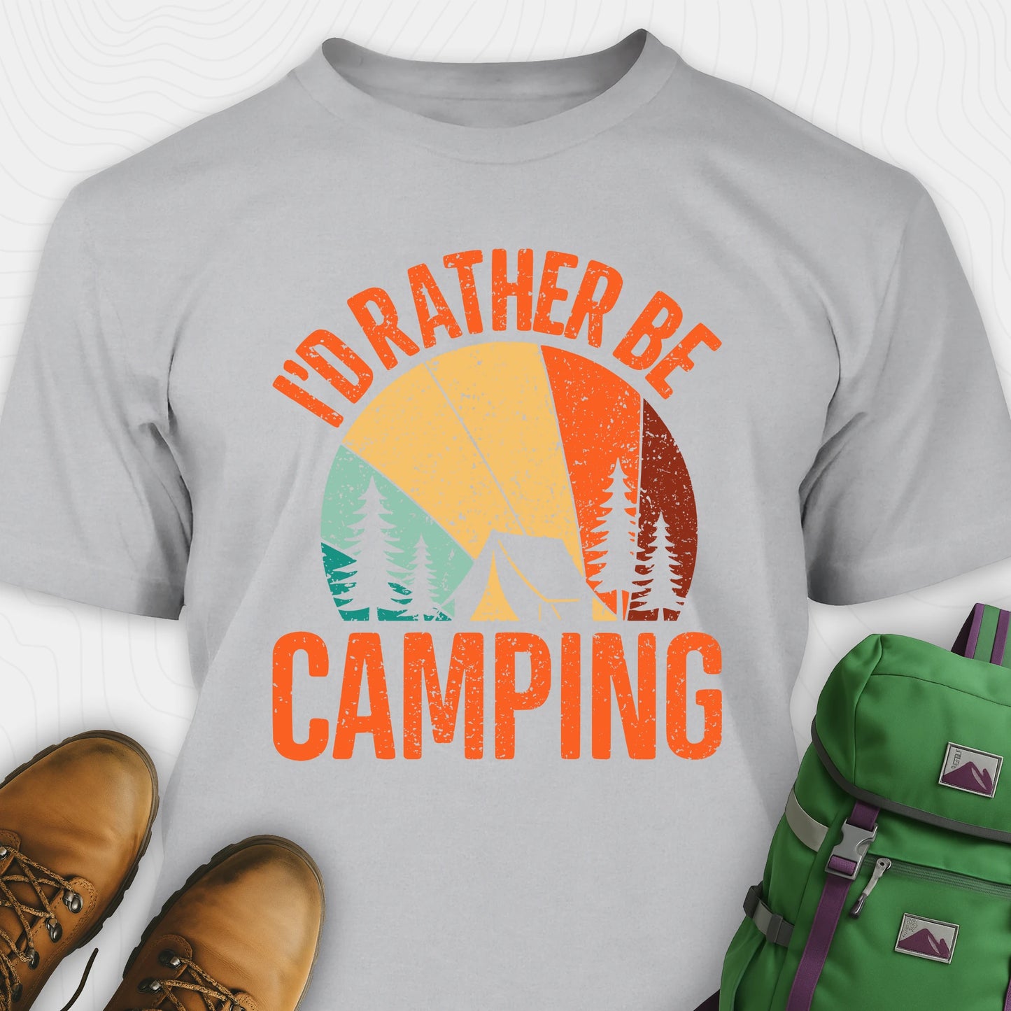Gray t-shirt with 'I'd Rather Be Camping' design, brown boots, and green backpack on a white background
