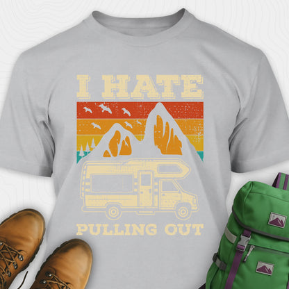 Grey I hate pulling out shirt with a graphic design of an RV and mountains, displayed with brown boots and a green backpack.