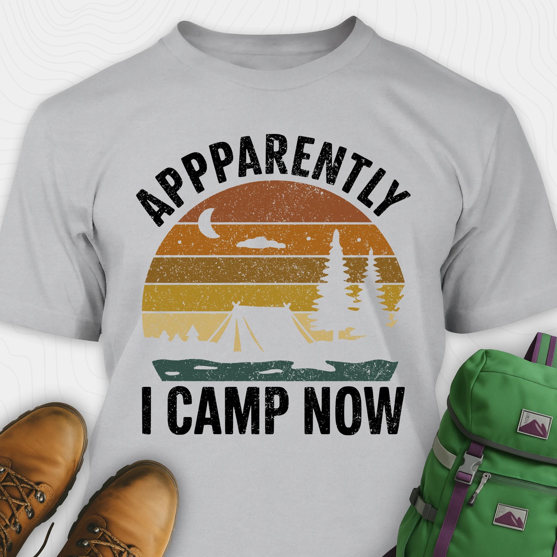 Sport Grey t-shirt with “Apparently I Camp Now” in white text and a vintage sunset camping scene with tent, trees, and moon.