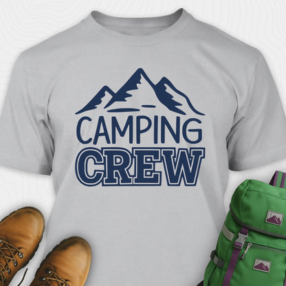 Gray camping crew t-shirt with 'Camping Crew' text and mountain graphic, paired with hiking boots and a green backpack.