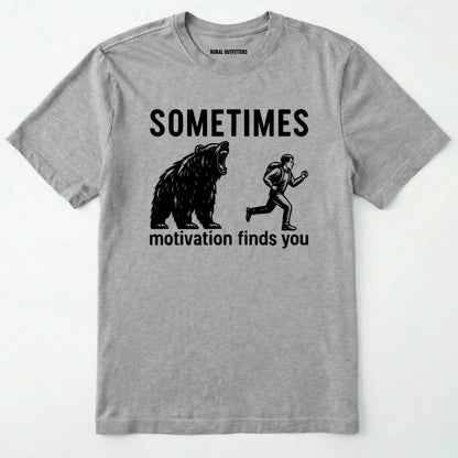Sport Grey motivational t-shirt with bear and person graphic and text 'sometimes motivation finds you' on a white background.
