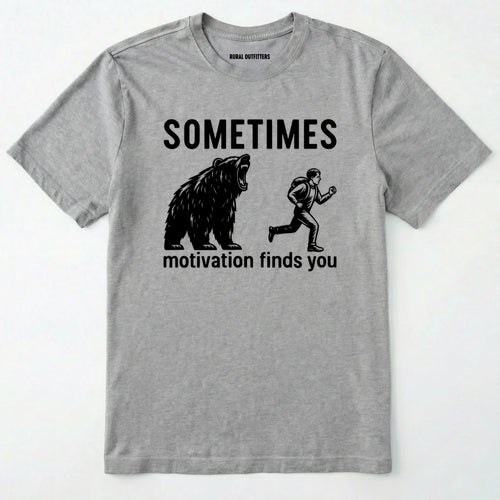 Sport Grey motivational t-shirt with bear and person graphic and text 'Sometimes motivation finds you' on a white background.