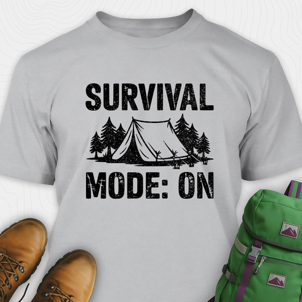 Grey bushcraft shirt with survival mode on text, featuring tent and pine tree design