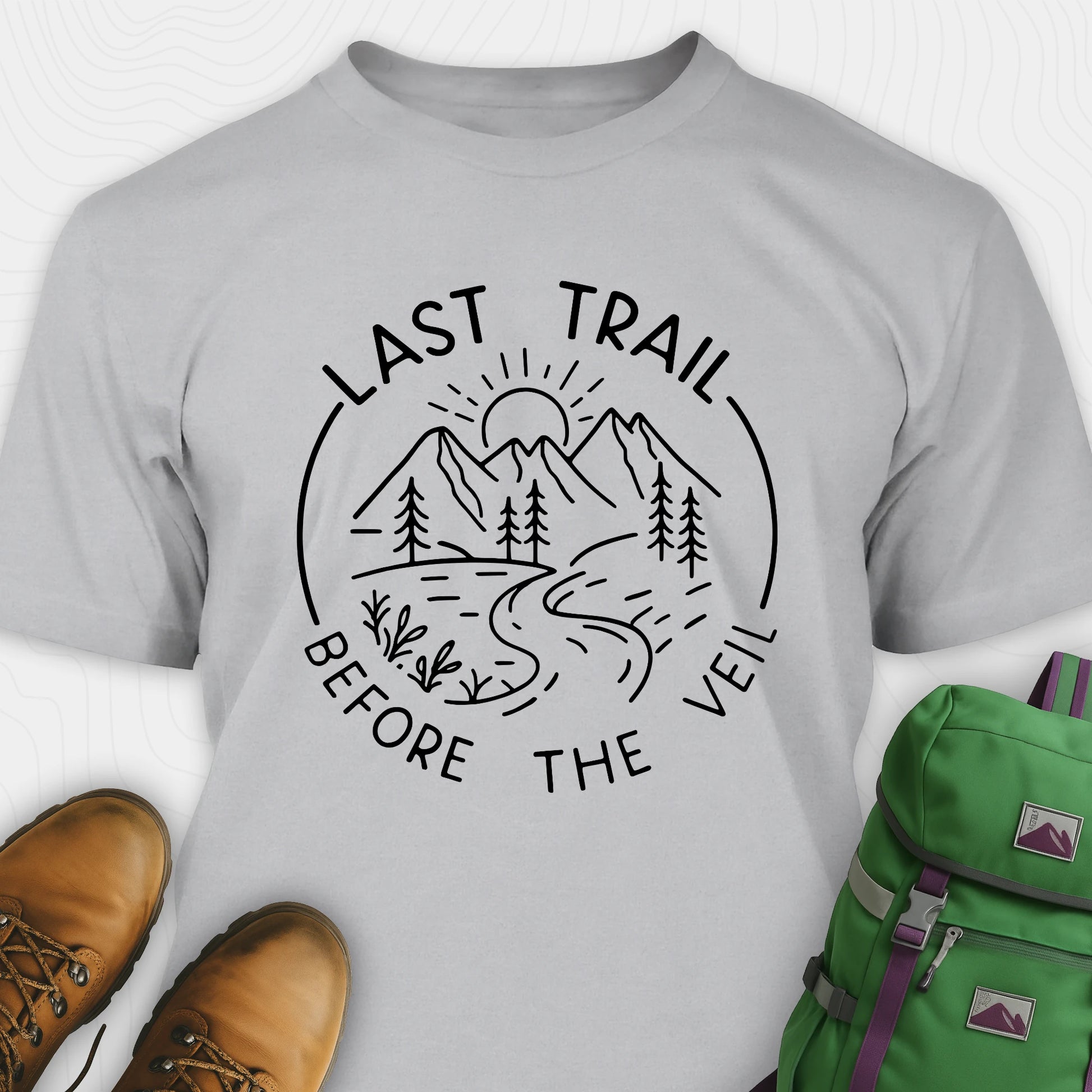 Grey nature-themed Last Trail Before the Veil shirt with line-art mountain scene.