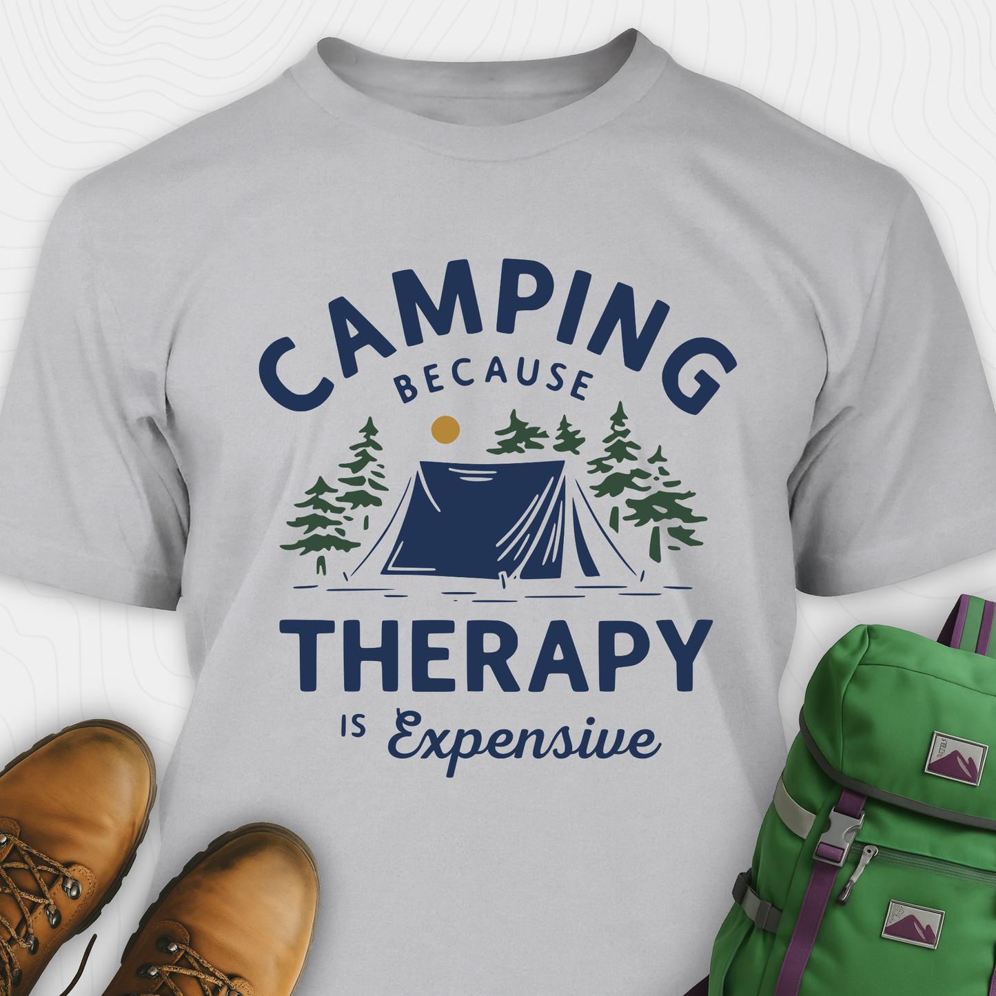 Gray camping therapy shirt with tent and pine trees design and "camping because therapy is expensive" text
