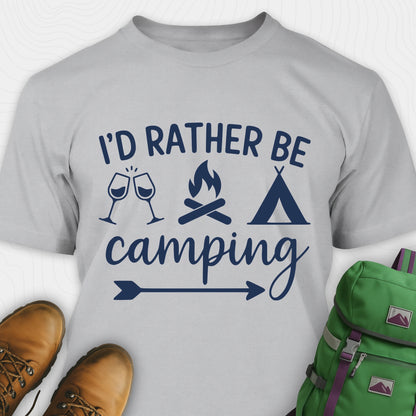 Sport grey women's camping shirt with 'I'd Rather Be Camping' design, brown boots, and green backpack on a white background