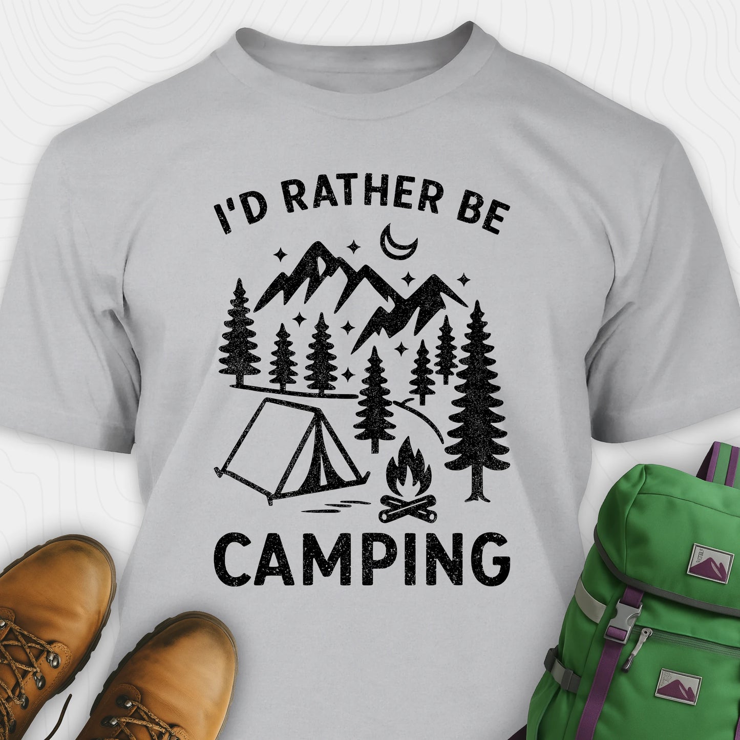Gray t-shirt with 'I'd Rather Be Camping' design, brown boots, and green backpack on a white background