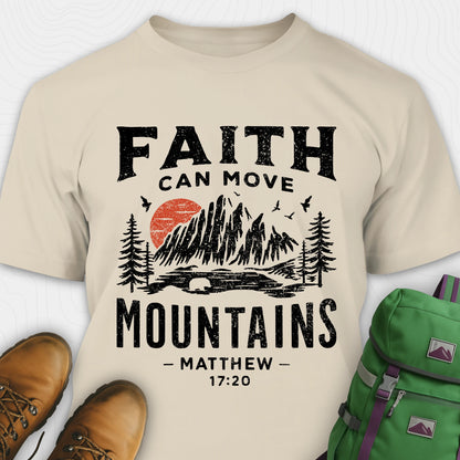 Sand bible verse t-shirt with 'Faith can move mountains' design and hiking boots and backpack on a white background