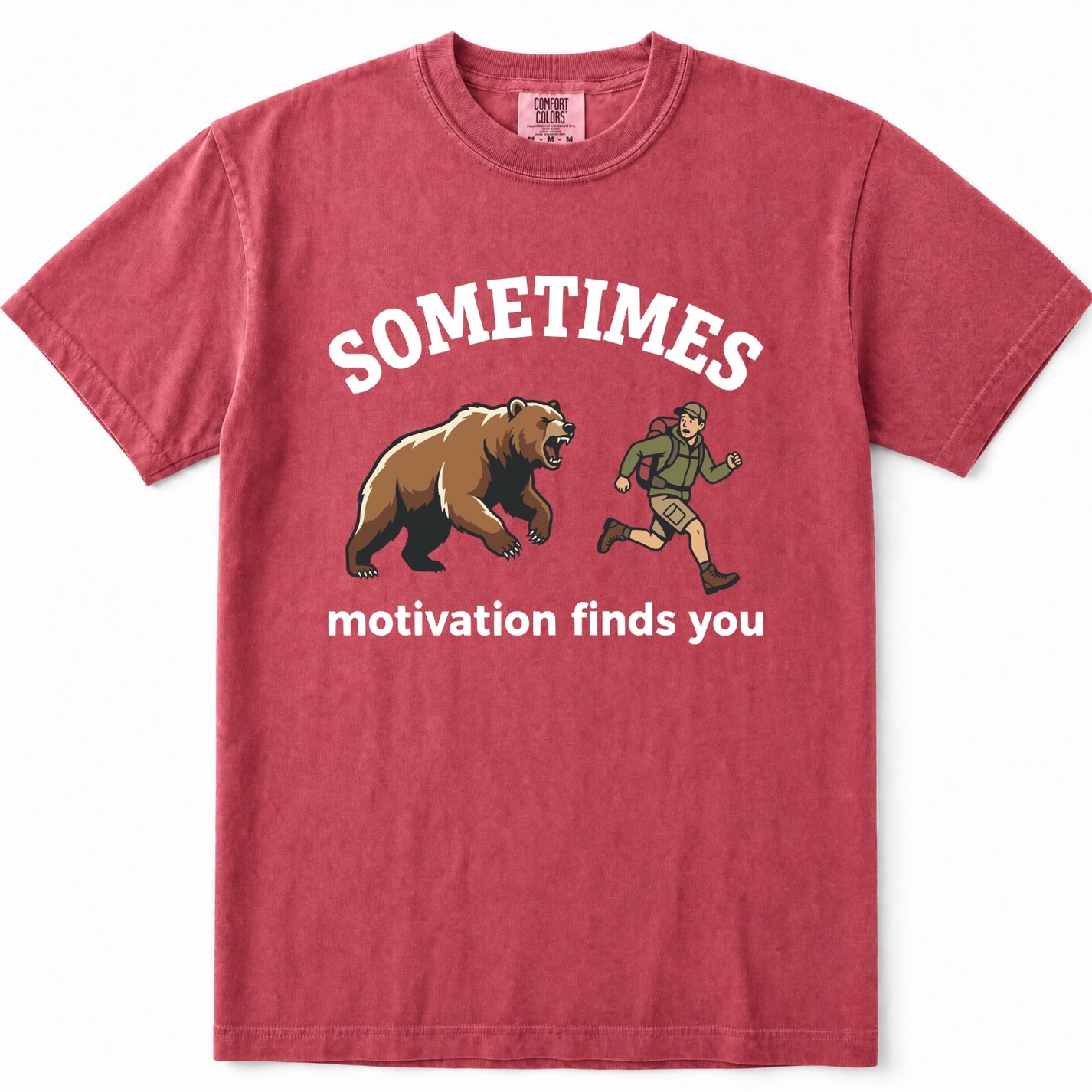 Crimson crewneck t-shirt with a graphic print showing a brown grizzly bear and a hiker, with the text 'SOMETIMES motivation finds you' in white.