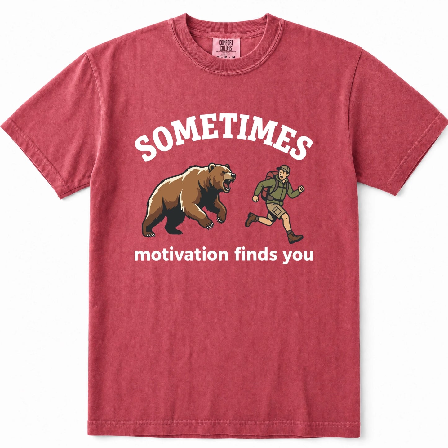 Crimson crewneck t-shirt with a graphic print showing a brown grizzly bear and a hiker, with the text 'SOMETIMES motivation finds you' in white.