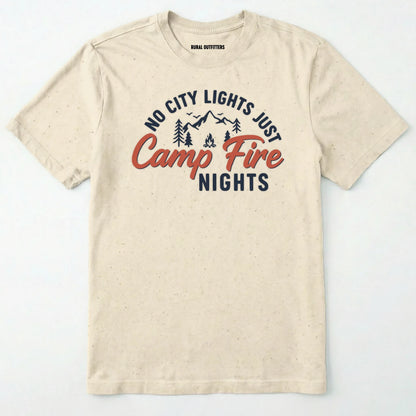 Natural campfire shirt with mountains and trees design and "no city lights just campfire nights" text on a white background.