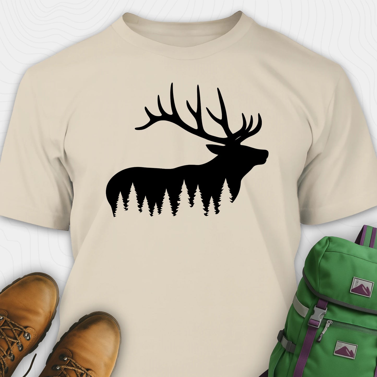 Natural  elk shirt with black elk silhouette design, paired with brown boots and a green backpack on a white background.
