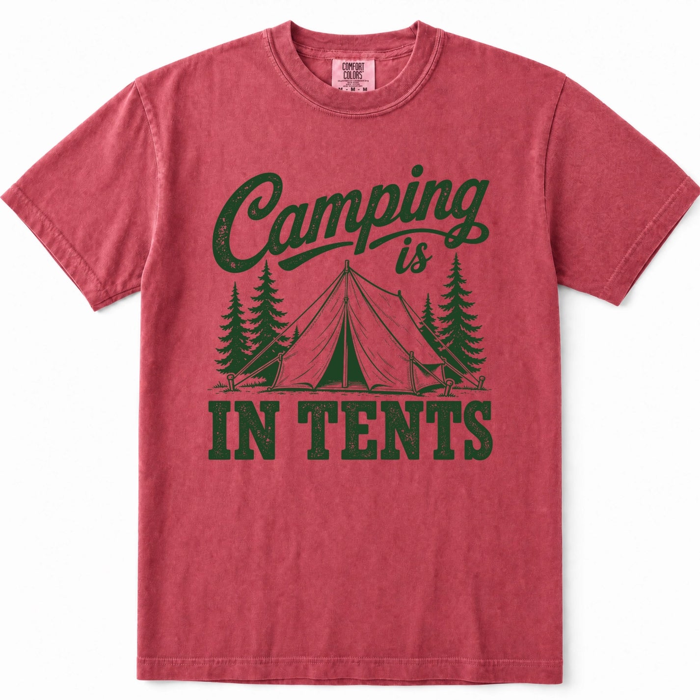 Crimson short-sleeve crewneck t-shirt in a washed, heathered red color, featuring a dark green graphic print on the front that reads 'Camping is IN TENTS' with an illustration of a tent and pine trees.