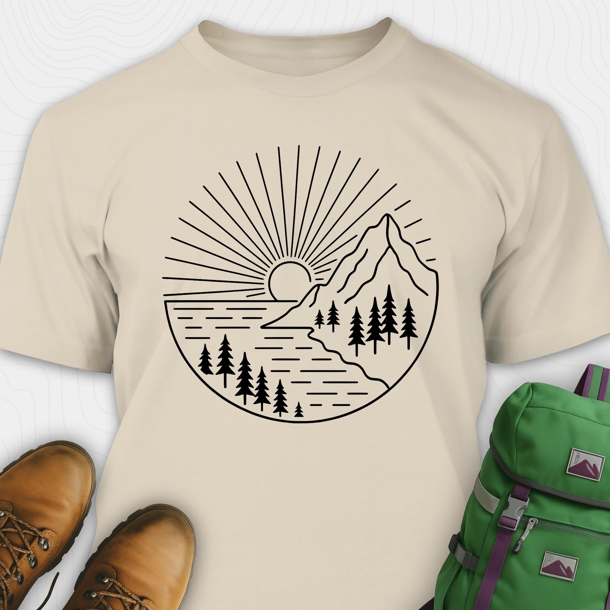 Sand mountain t-shirt with a white line-art design of mountains, trees, and a sunrise.