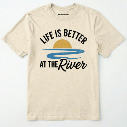 Natural river shirt with 'life is better at the river' design, paired with brown boots and a green backpack on a light grey background.