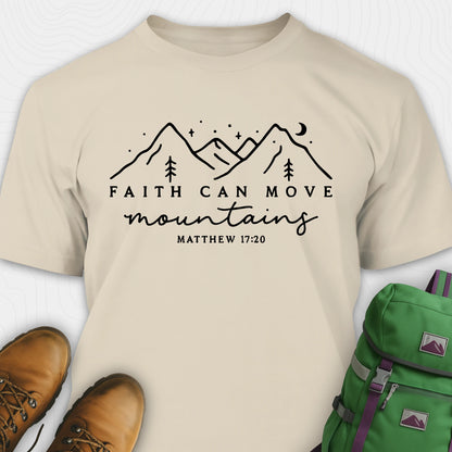 Sand faith can move mountains shirt with mountain scripture design, paired with hiking boots and a green backpack.