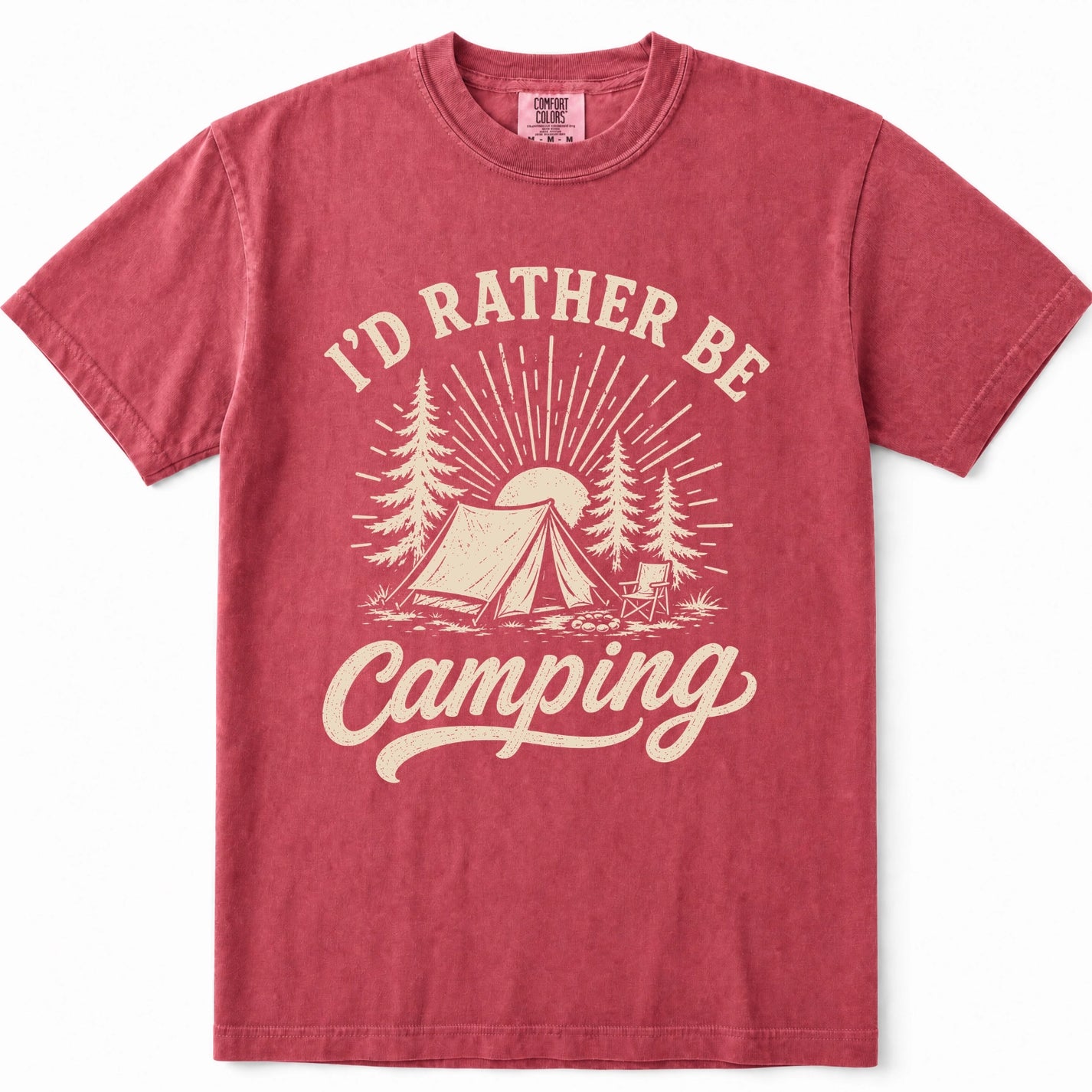 Crimson short-sleeve crewneck t-shirt in a washed, heathered red color, featuring a cream-colored graphic print on the front with the text 'I'D RATHER BE Camping' and an illustration of a tent, trees, and a sun.