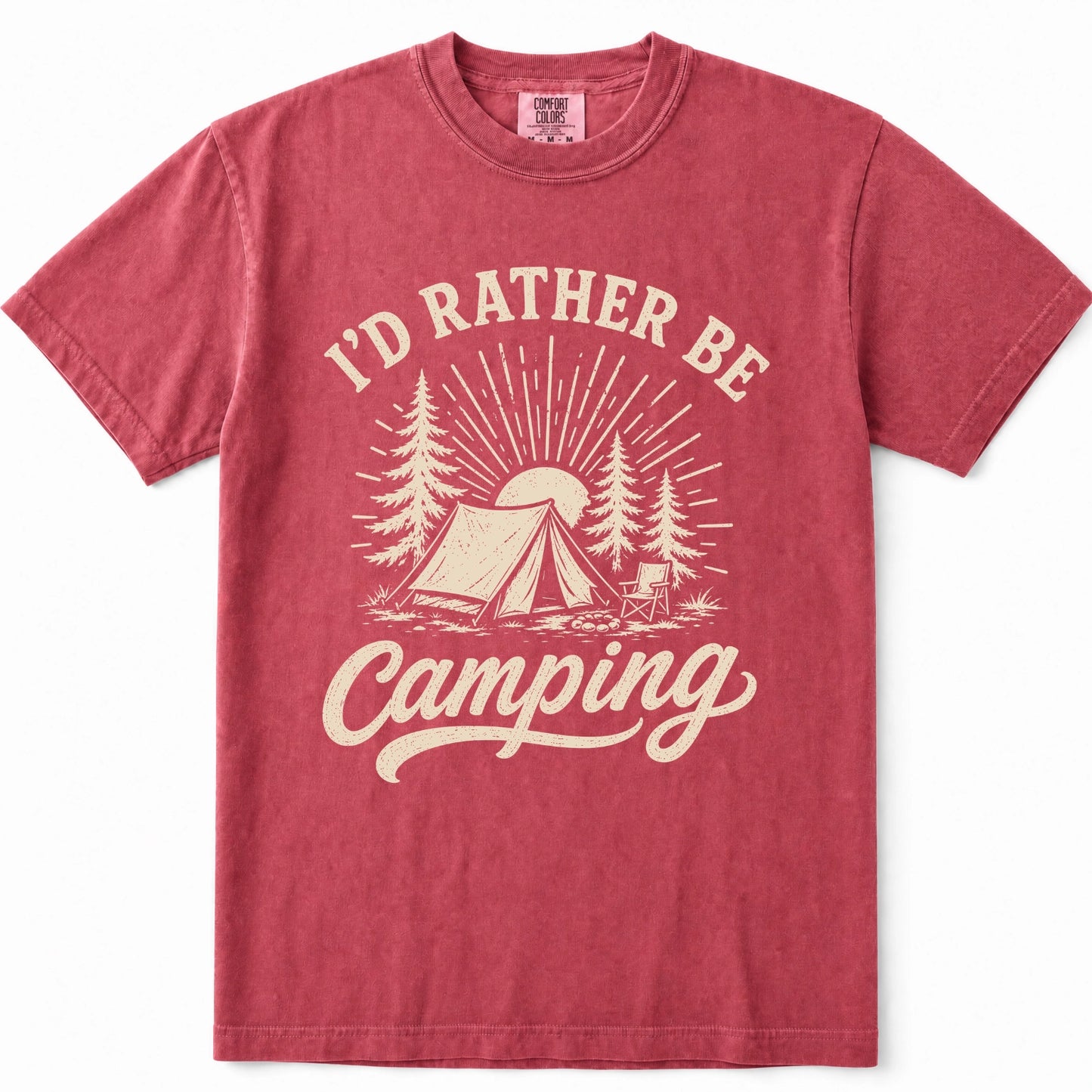 Crimson short-sleeve crewneck t-shirt in a washed, heathered red color, featuring a cream-colored graphic print on the front with the text 'I'D RATHER BE Camping' and an illustration of a tent, trees, and a sun.