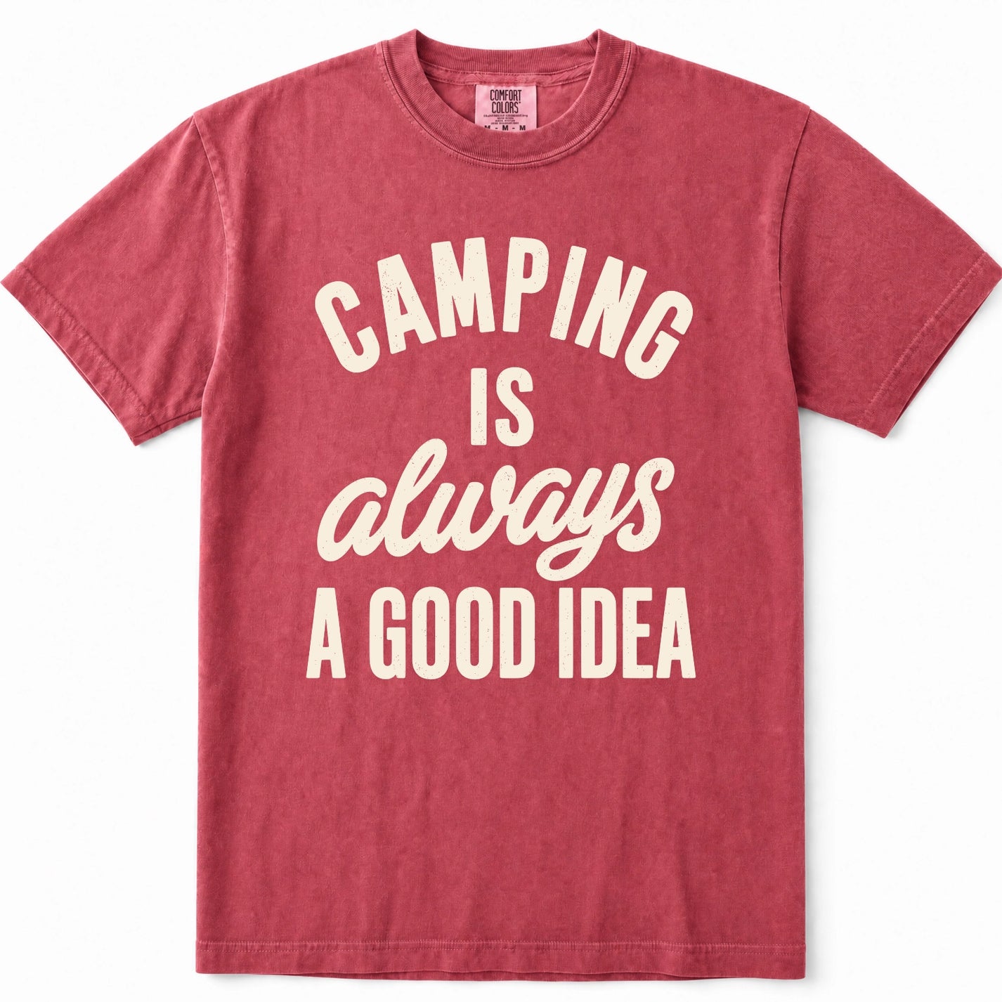 Crimson short-sleeve crewneck t-shirt in a washed, heathered red color, featuring the phrase 'CAMPING IS always A GOOD IDEA' printed on the front in cream-colored lettering.