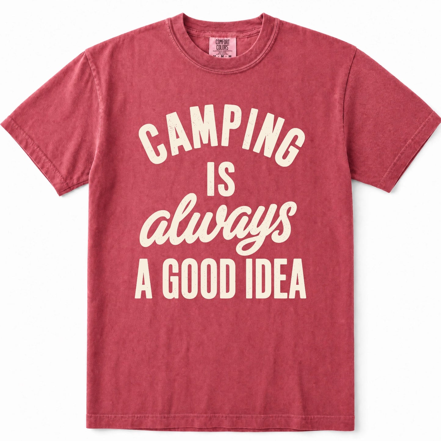 Crimson short-sleeve crewneck t-shirt in a washed, heathered red color, featuring the phrase 'CAMPING IS always A GOOD IDEA' printed on the front in cream-colored lettering.