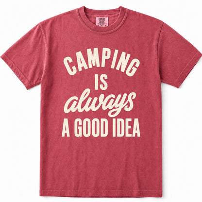 Crimson short-sleeve crewneck t-shirt in a washed, heathered red color, featuring the phrase 'CAMPING IS always A GOOD IDEA' printed on the front in cream-colored lettering.