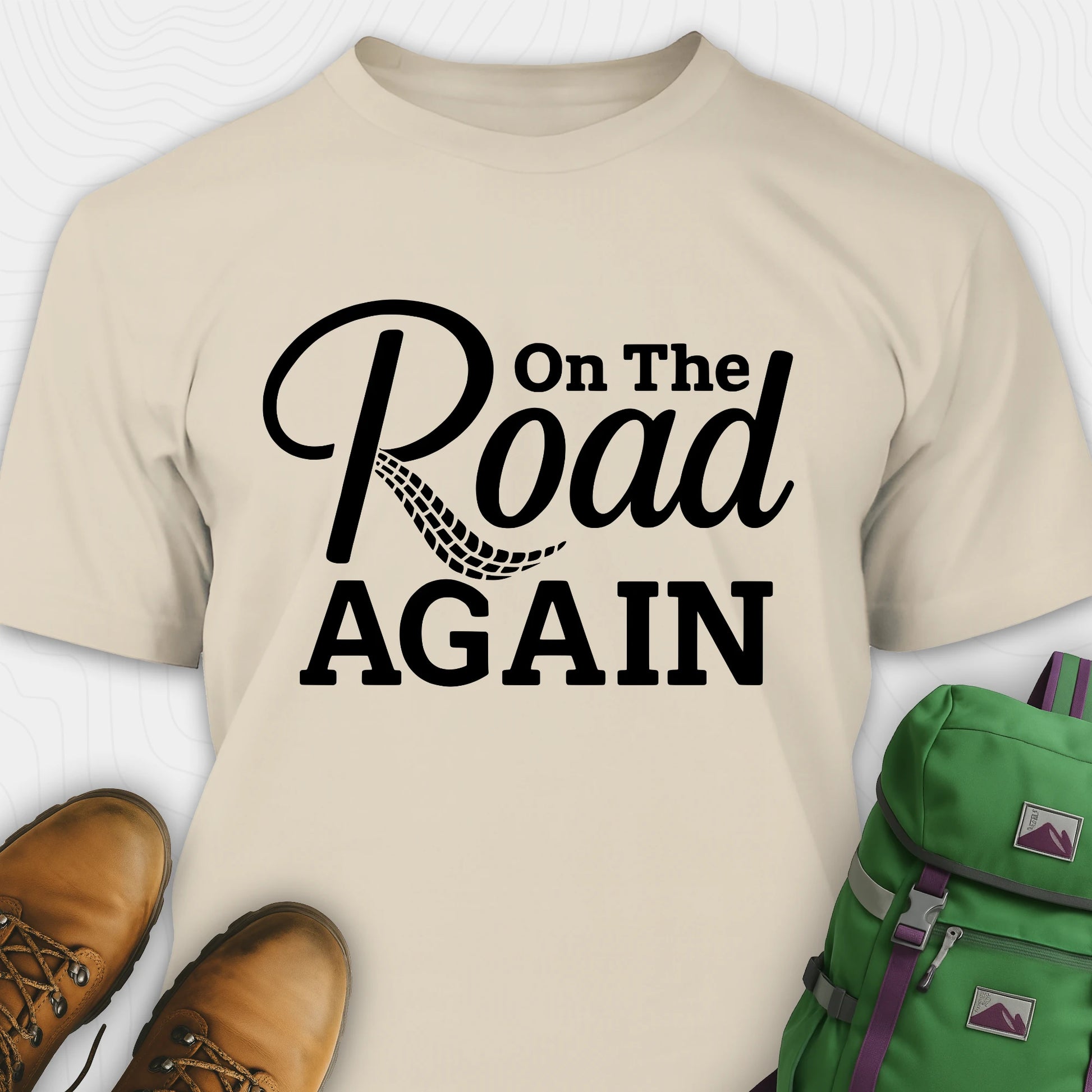 Sand road trip t-shirt with “on the road again” black text