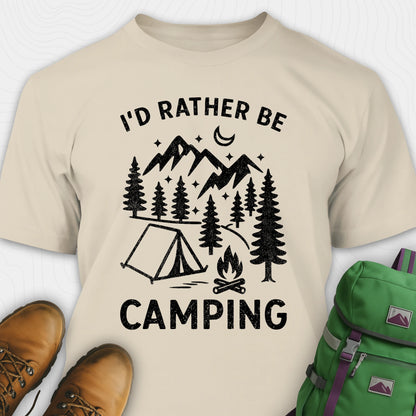 Beige t-shirt with camping graphic and text, paired with brown boots and a green backpack.