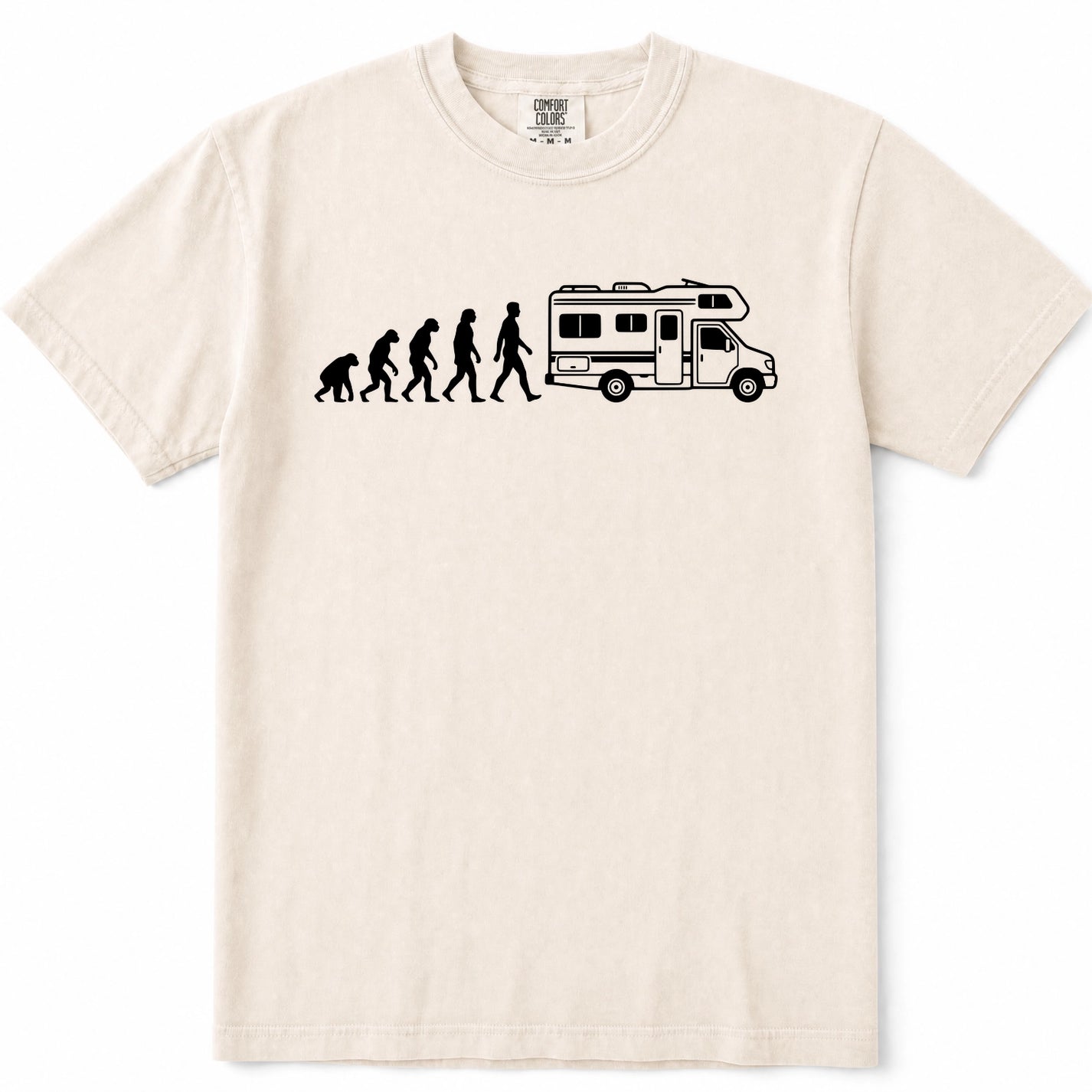 Ivory crewneck t-shirt featuring a black graphic print of the evolution of man transforming into a woman, who then drives a white and black camper RV. The shirt is displayed flat against a clean white background.