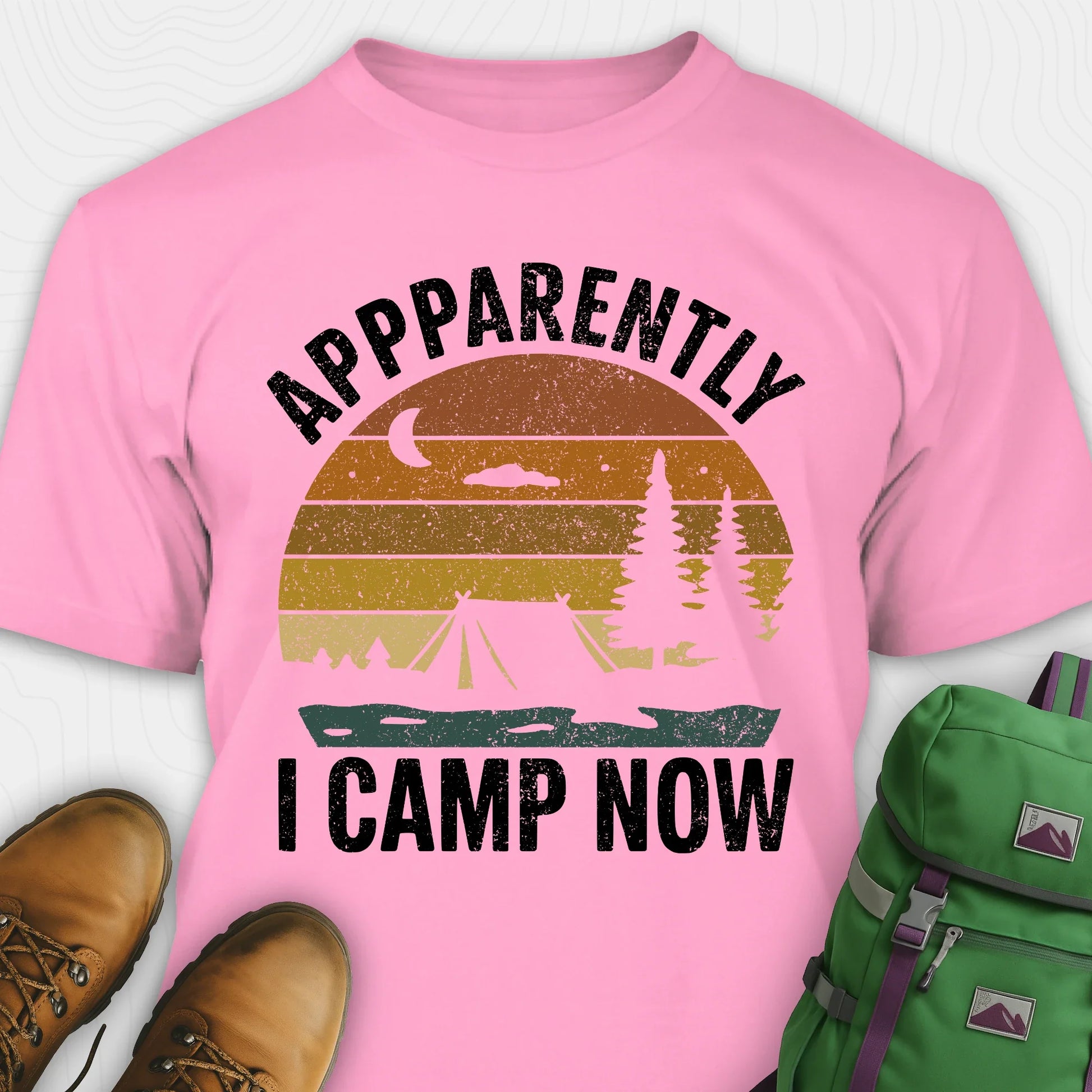 Azalea t-shirt with “Apparently I Camp Now” in white text and a vintage sunset camping scene with tent, trees, and moon.