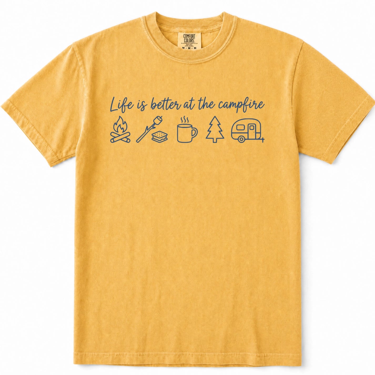 Mustard yellow crewneck t-shirt with a blue graphic print that reads 'Life is better at the campfire' above simple line drawings of a campfire, a marshmallow, a mug, a tree, and a trailer, shown on a plain white background.