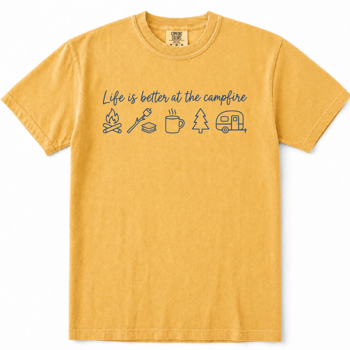 Mustard yellow crewneck t-shirt with a blue graphic print that reads 'Life is better at the campfire' above simple line drawings of a campfire, a marshmallow, a mug, a tree, and a trailer, shown on a plain white background.
