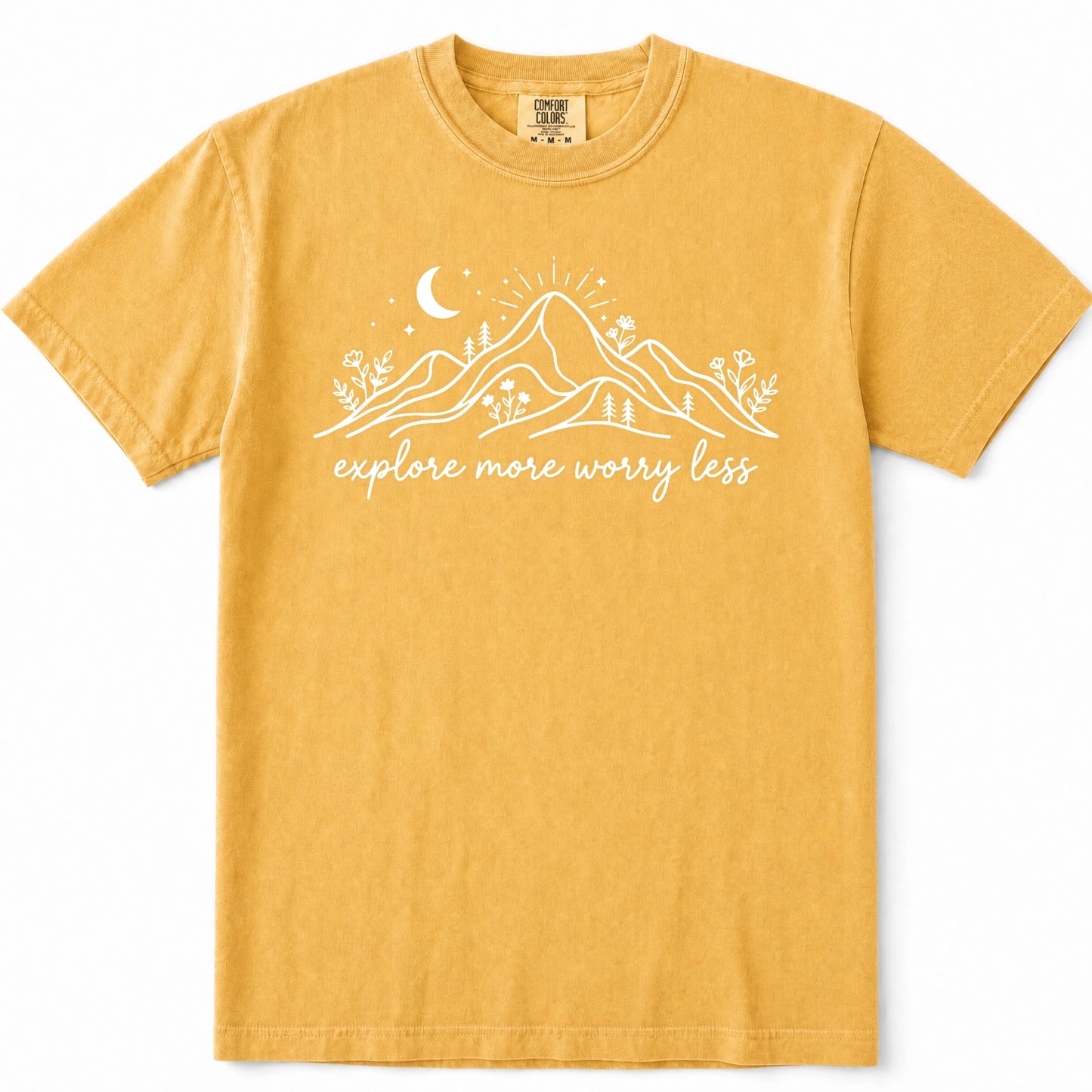 Mustard short-sleeve crewneck t-shirt with a white graphic of mountains, a crescent moon, and the text 'explore more worry less' printed on the front.
