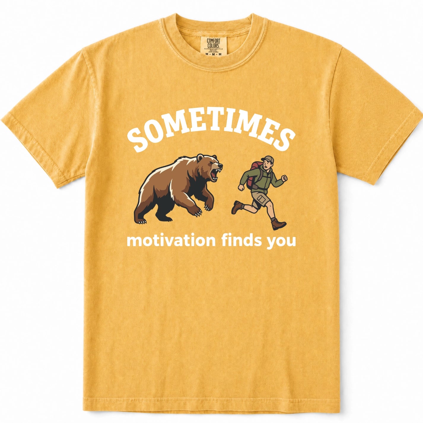 Mustard short-sleeve crewneck t-shirt with a graphic print featuring a brown grizzly bear and a running hiker, with the text 'SOMETIMES motivation finds you' in white.