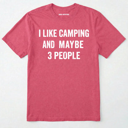 Heather Cardinal short-sleeve t-shirt with bold white text reading 'I LIKE CAMPING AND MAYBE 3 PEOPLE' across the chest, laid flat against a light off-white background.