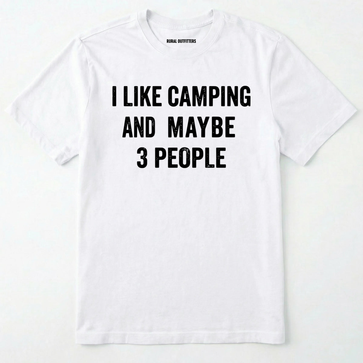 White short-sleeve t-shirt with bold black text reading 'I LIKE CAMPING AND MAYBE 3 PEOPLE' across the chest, laid flat against a light off-white background.